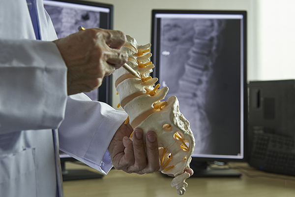 dr. javier reto explains orthopedic spine surgery to a patient