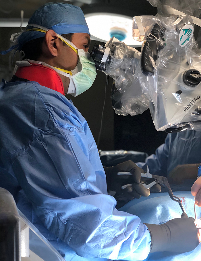 orthopedic spine surgeon dr. javier reto operates on patient